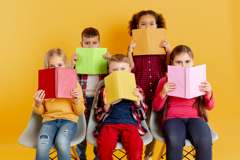 Happy children reading colourful books